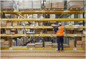 An image of a man stacking a shelf in a warehouse