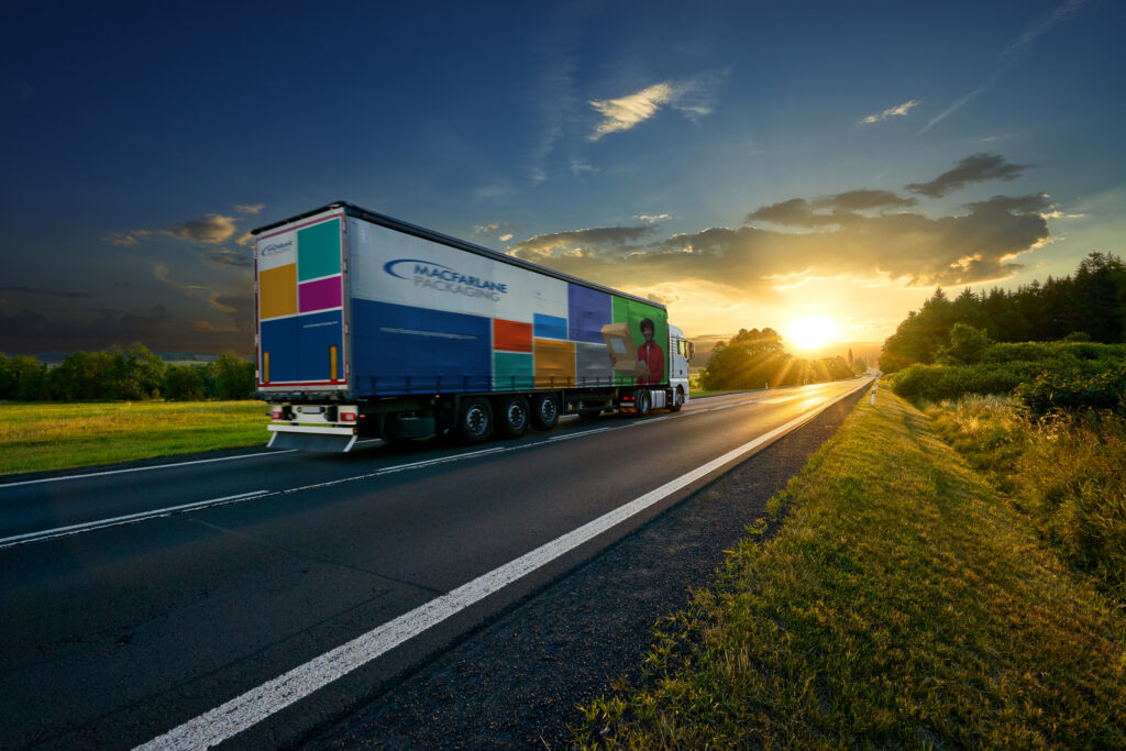 An image of a Macfarlane Packaging truck driving into the sunset