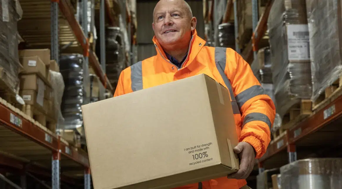 Gerry Gorman from Macfarlane Packaging's Glasgow RDC shows off one of the new stock cardboard boxes that is now 100% recycled content