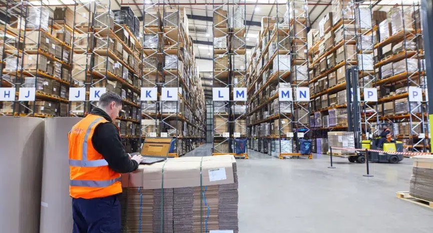 Image shows person working with stretch rapped pallet inside a Macfarlane regional distribution centre